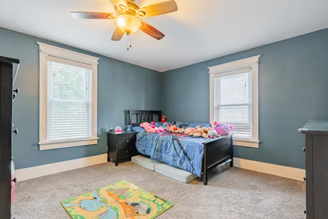 a living room with a bed and a chandelier