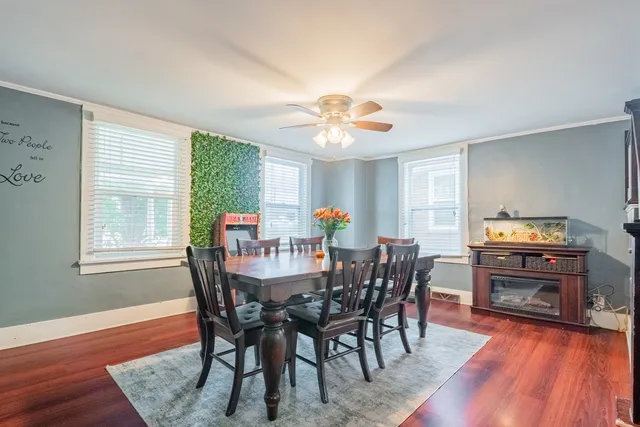 a view of a dining room with furniture window and wooden floor