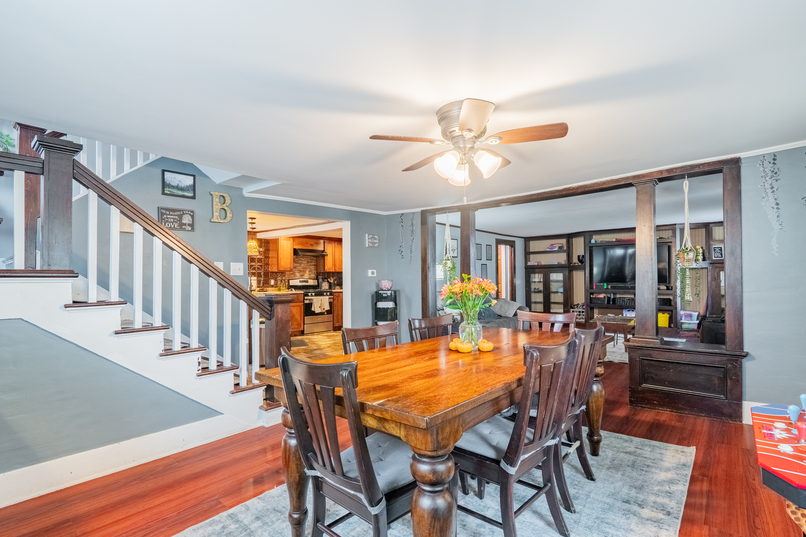 310 South Pleasant Street Princeton, IL 61356 - Photo 6 of 36 a view of a dining room and livingroom with furniture wooden floor a rug a painting and a chandelier