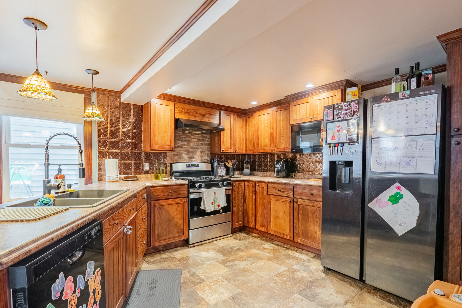 310 South Pleasant Street Princeton, IL 61356 - Photo 8 of 36 a kitchen with stainless steel appliances granite countertop sink stove and refrigerator