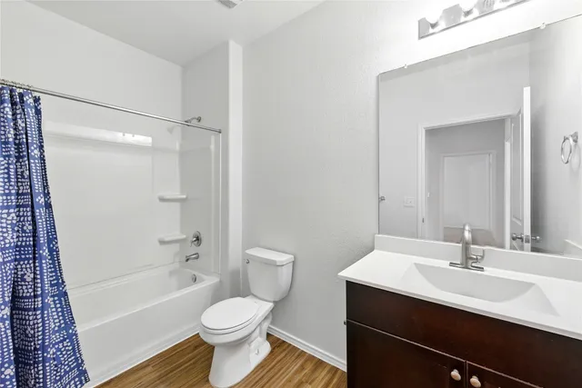 a bathroom with a sink toilet a mirror and shower