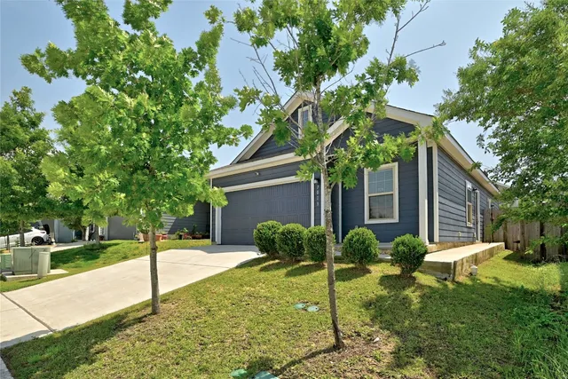 a house that has a tree in front of it