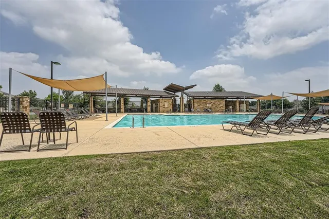 a view of a house with swimming pool and sitting area