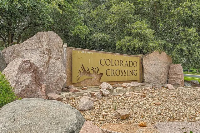 a sign board with a building in the background