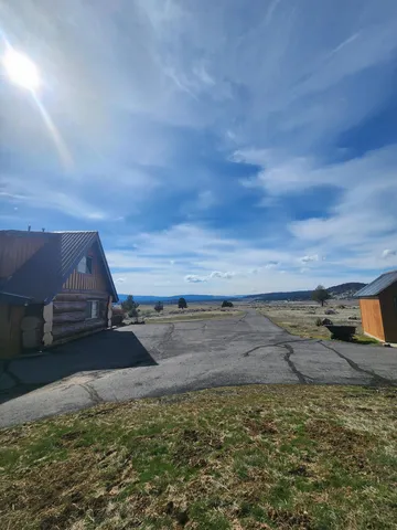 a yellow and red house sitting in the middle of a field