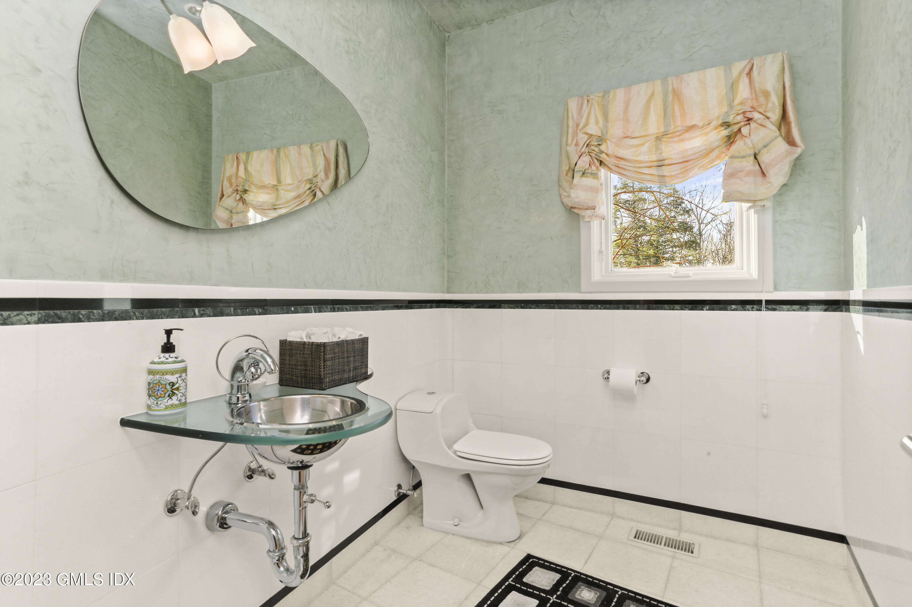 245 Long Close Road Stamford, CT 06902 - Photo 18 of 53 a bathroom with a sink and a mirror