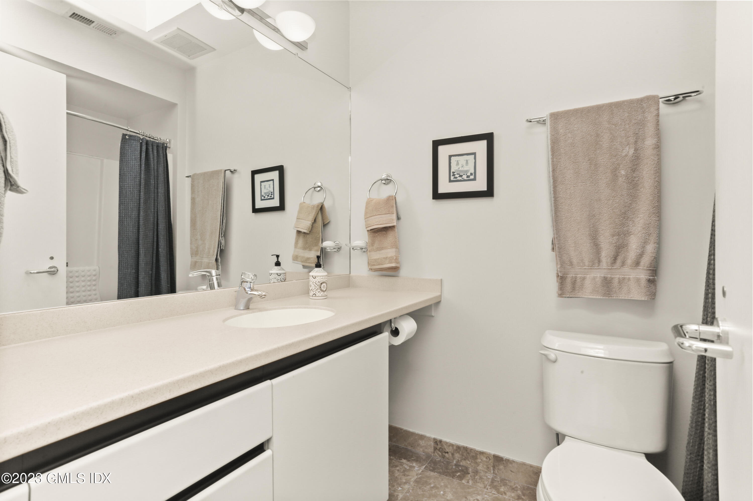 245 Long Close Road Stamford, CT 06902 - Photo 36 of 53 a bathroom with a toilet a sink and mirror