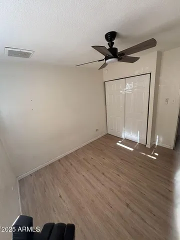 a view of a room with wooden floor