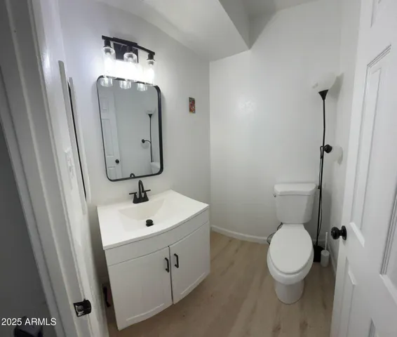 a bathroom with a toilet sink and mirror