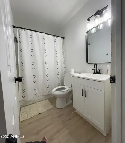 a bathroom with a toilet sink and shower