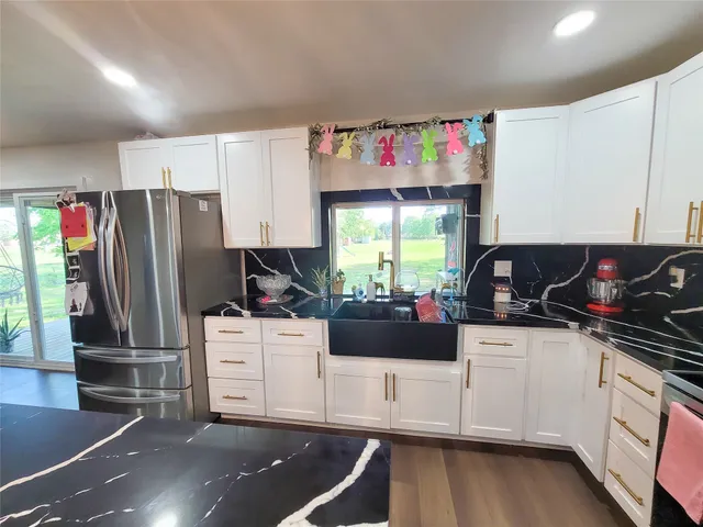 a kitchen with a refrigerator and a stove top oven