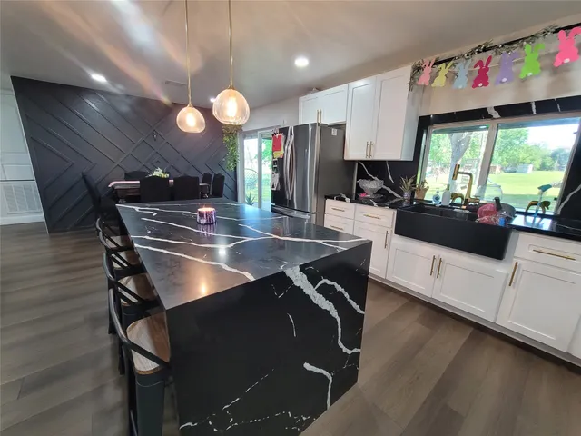 a kitchen with kitchen island granite countertop lots of counter top space and dining table