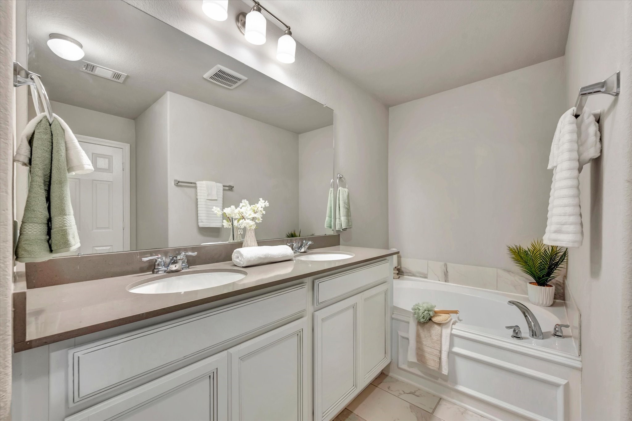 13420 Shellbark Way La Marque, TX 77568 - Photo 20 of 31 Beautiful ensuite bath with double sinks, quartz counters, and contemporary lighting.
