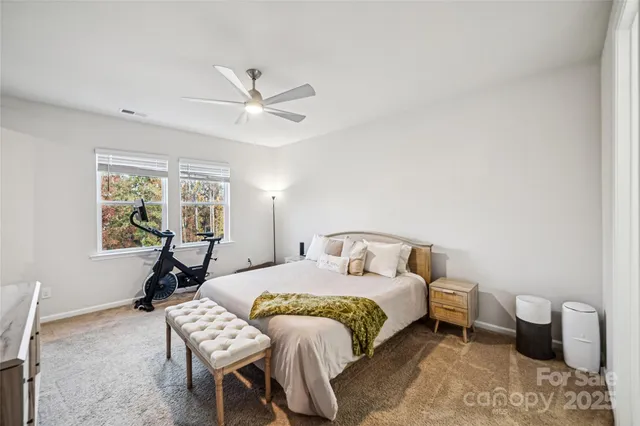 a bedroom with a bed and a couch