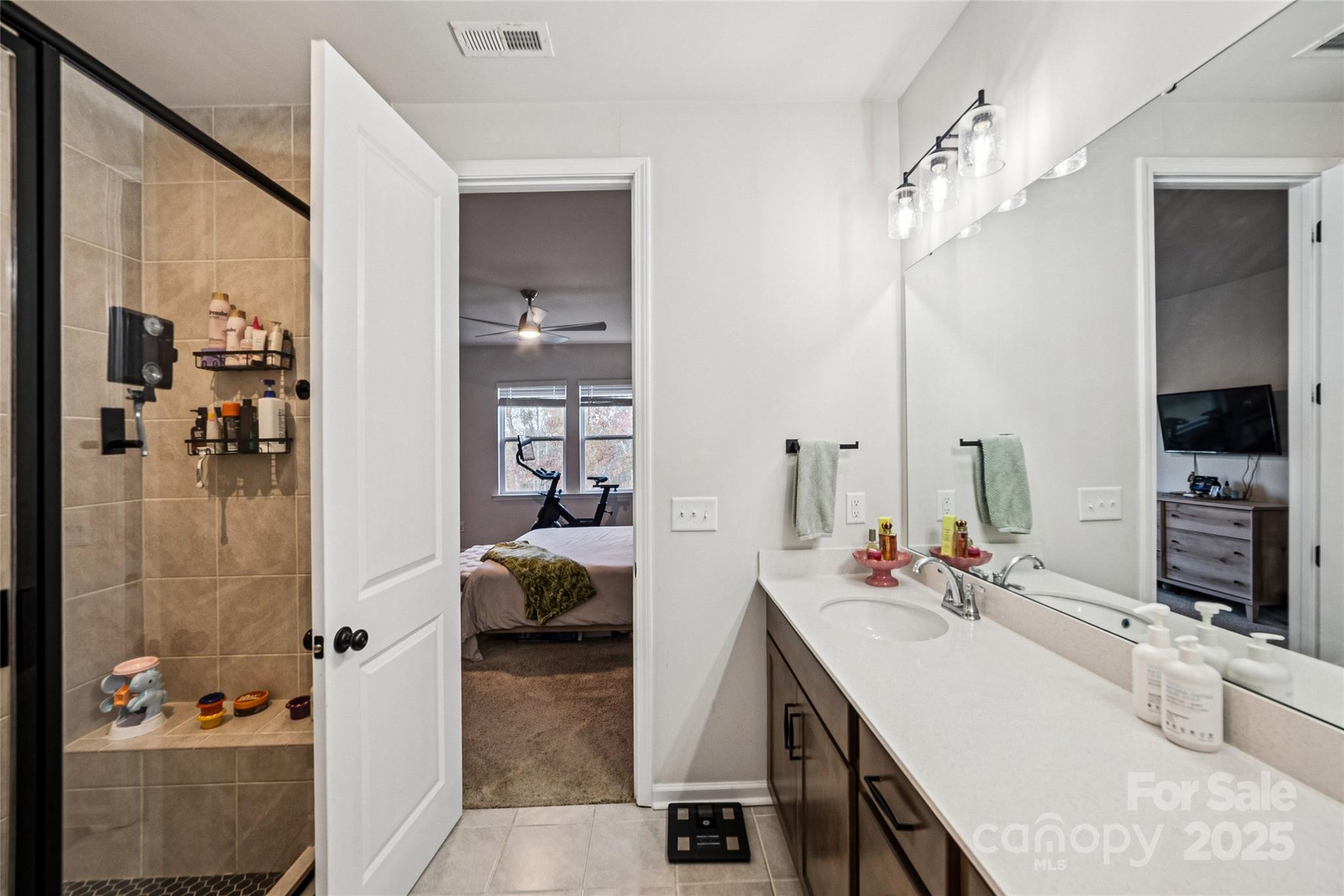 1103 Grays Ml Road Charlotte, NC 28215 - Photo 16 of 25 a en suite bathroom with a double vanity sink a mirror and shower