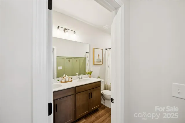 a bathroom with a sink double vanity and a mirror