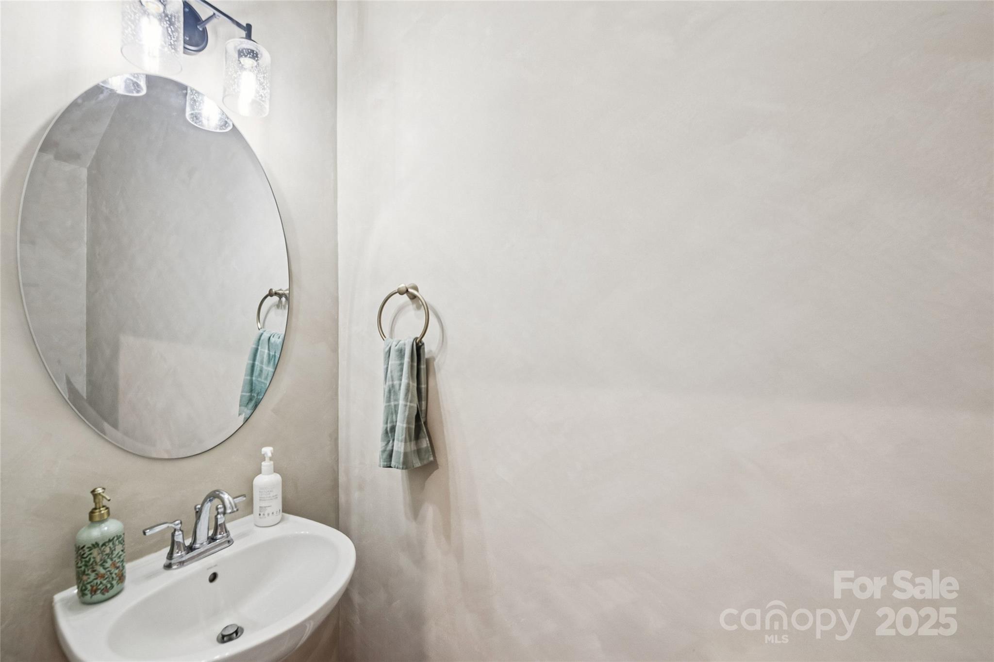 1103 Grays Ml Road Charlotte, NC 28215 - Photo 3 of 25 a bathroom with a sink and a mirror