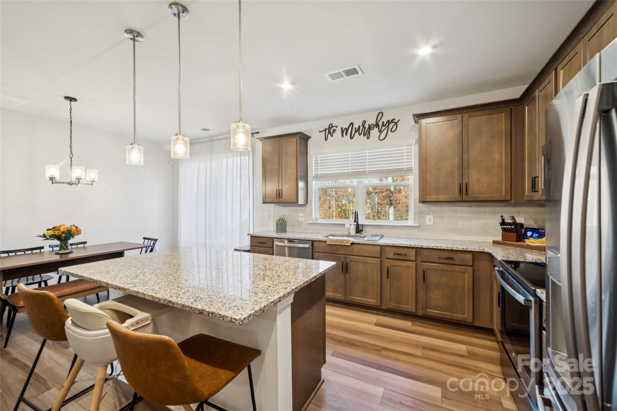 1103 Grays Ml Road Charlotte, NC 28215 - Photo 9 of 25 a kitchen with stainless steel appliances granite countertop a sink a stove and a refrigerator