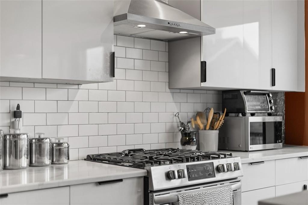 5229 Duncan Street Pittsburgh, PA 15201 - Photo 5 of 16 a kitchen with granite countertop a stove and a sink