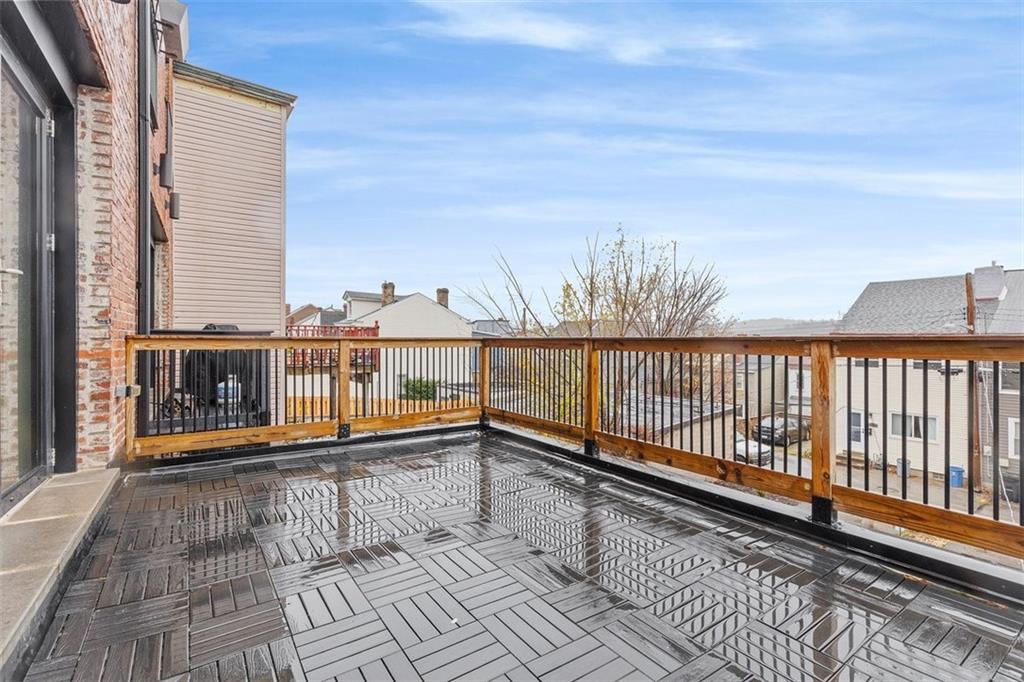 5229 Duncan Street Pittsburgh, PA 15201 - Photo 6 of 16 a view of a balcony with wooden floor and fence
