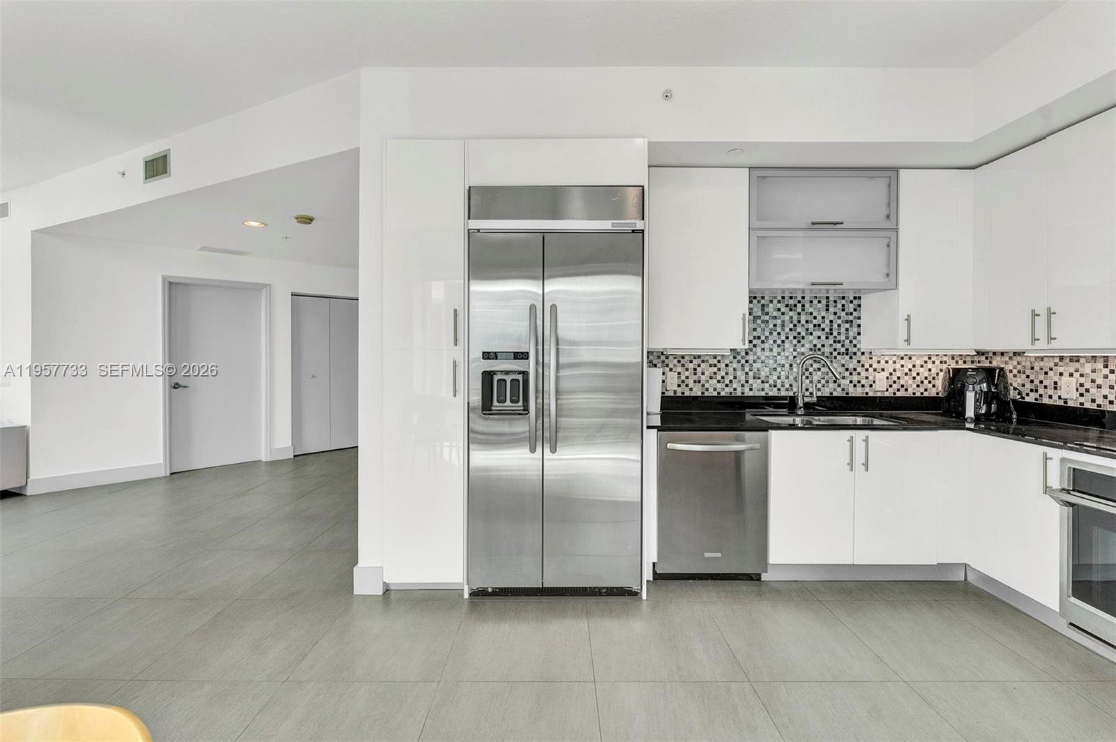 60 Southwest 13th Street, Unit 3400 Miami, FL 33130 - Photo 10 of 50 a kitchen with stainless steel appliances a refrigerator sink and cabinets