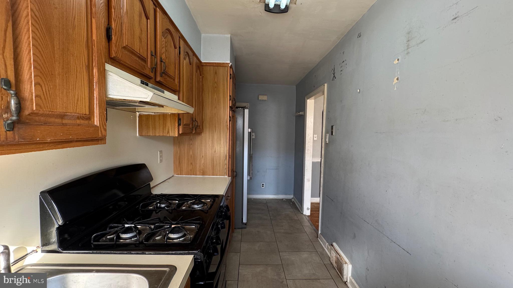 2922 Fanshawe Street Philadelphia, PA 19149 - Photo 8 of 21 a kitchen with a stove and a refrigerator