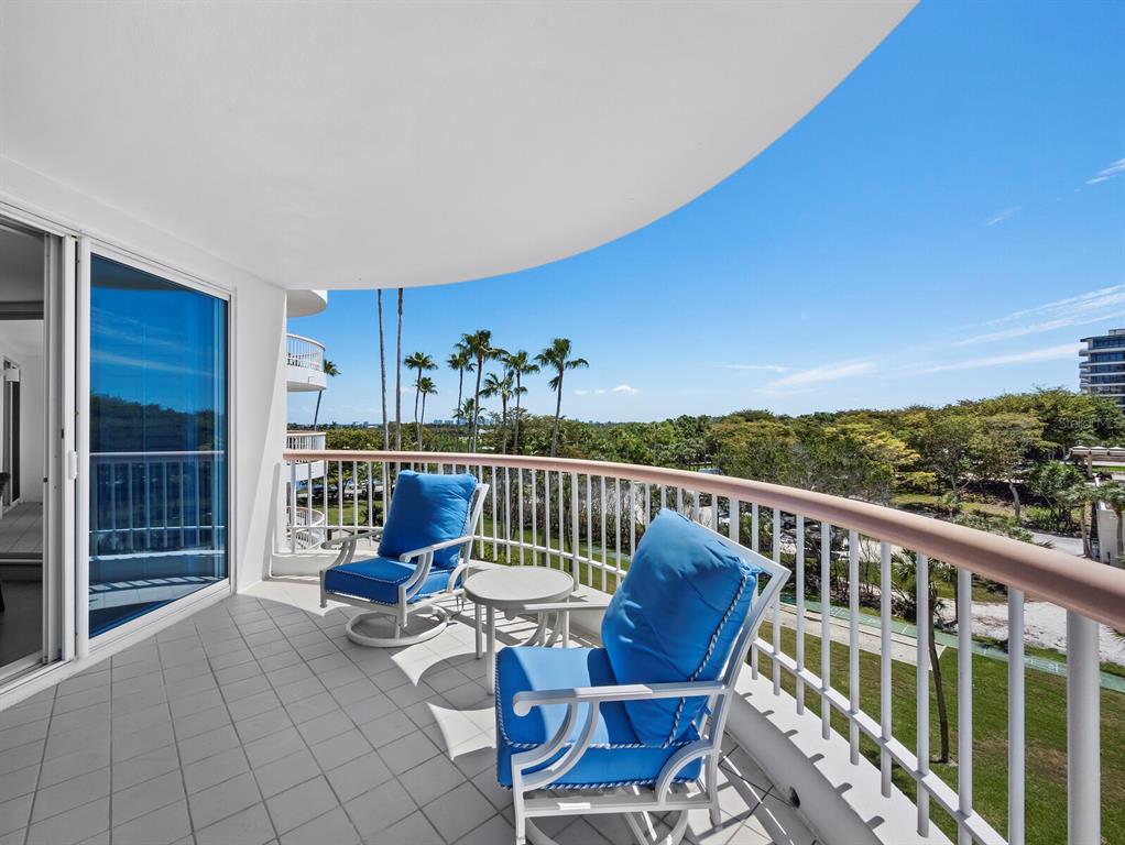 455 Longboat Club Road, Unit 402 Longboat Key, FL 34228 - Photo 7 of 48 a view of a chairs in wooden deck