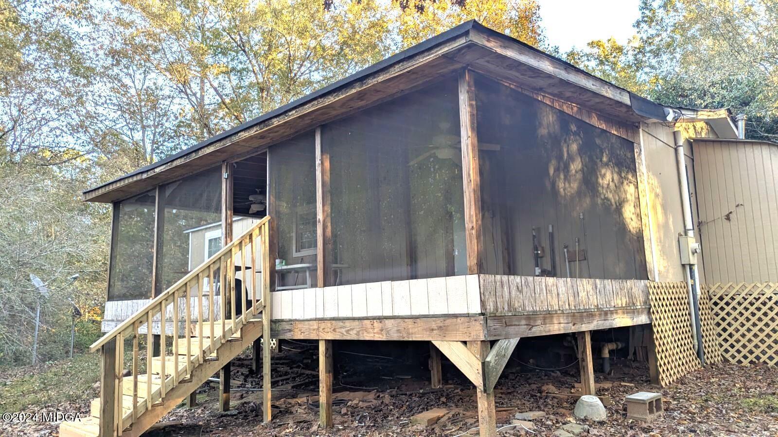 3091 Tribble Road Fort Valley, GA 31030 - Photo 5 of 7 a backyard of a house with table and chairs