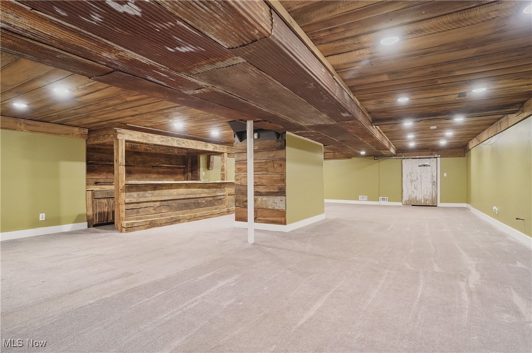 1453 Prospect Road Hudson, OH 44236 - Photo 35 of 50 Finished below grade area with wooden ceiling, carpet floors, and wooden walls