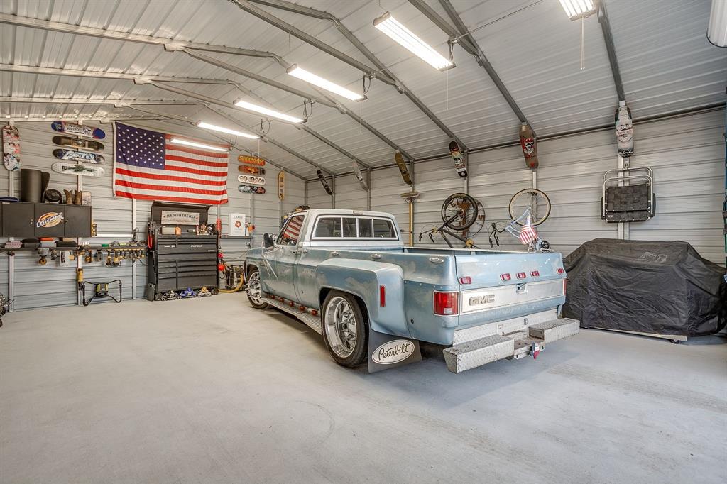 1008 Dapple Gray Road Crowley, TX 76036 - Photo 36 of 40 10 ft rollup door at the front of the shop, LED lighting and concrete flooring.