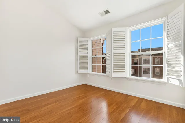 a view of an empty room and wooden floor