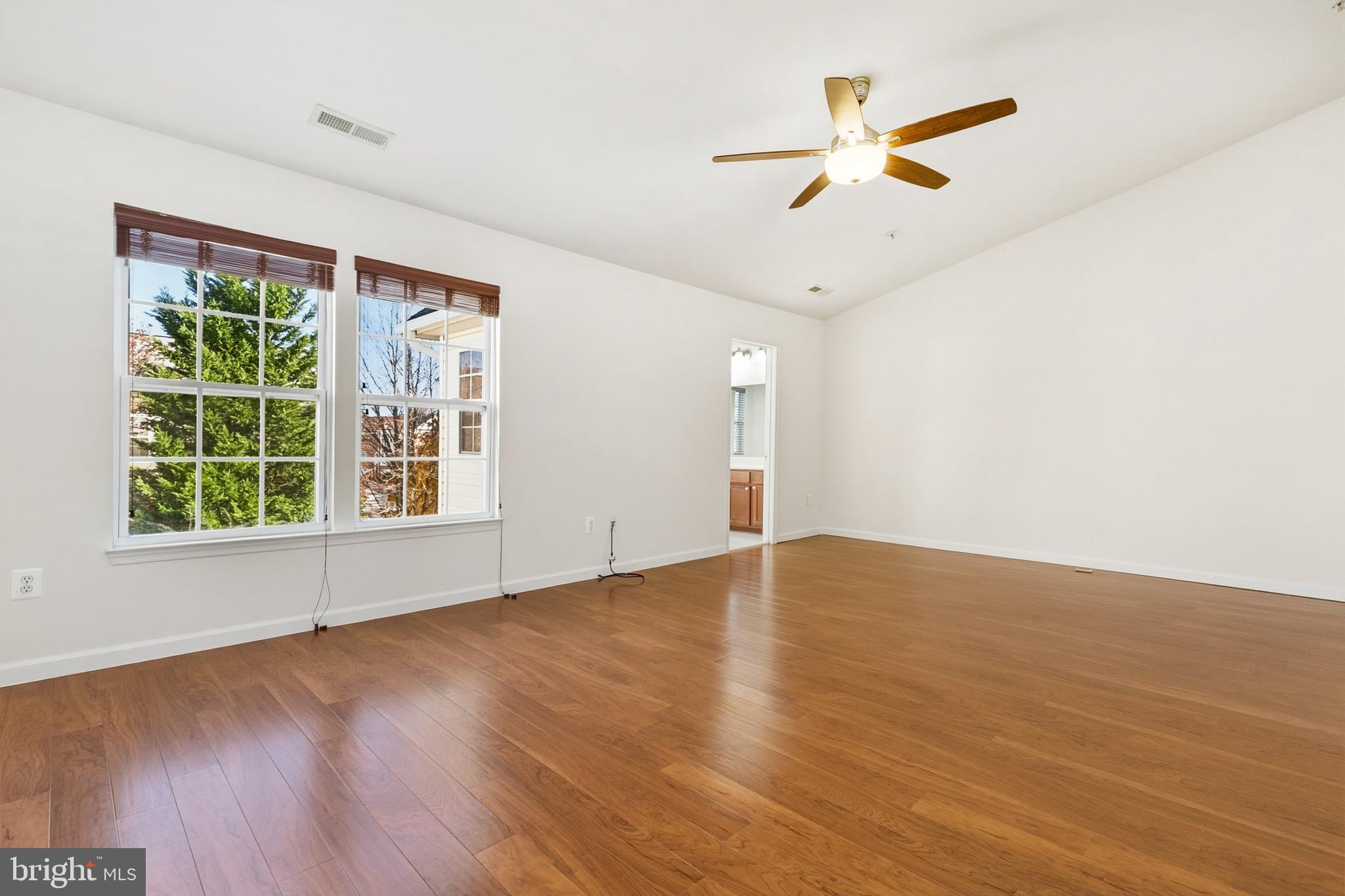 9956 Fragrant Lilies Way Laurel, MD 20723 - Photo 33 of 60 wooden floor in an empty room with a window