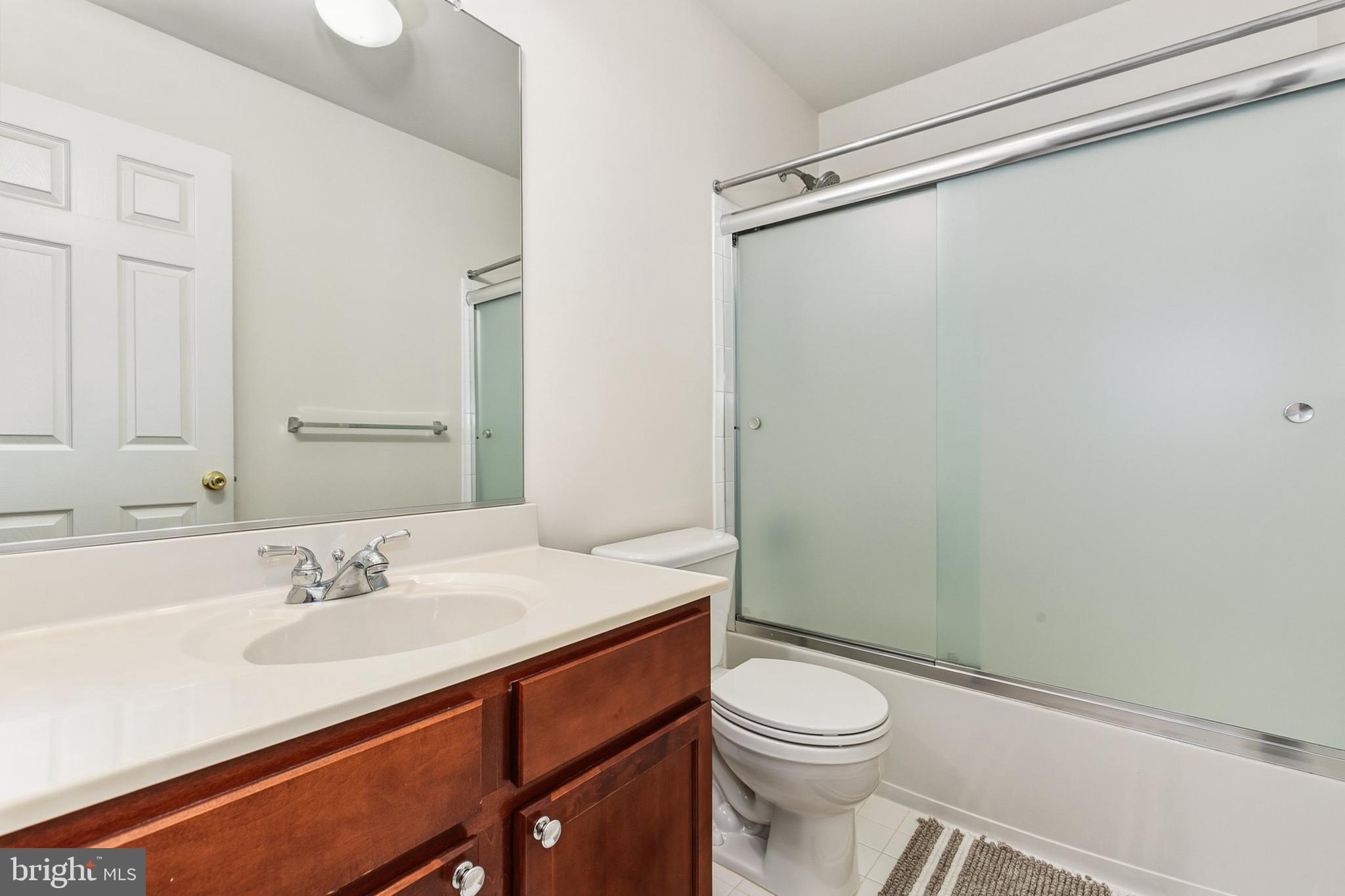 9956 Fragrant Lilies Way Laurel, MD 20723 - Photo 34 of 60 a bathroom with a sink a toilet a shower and a mirror