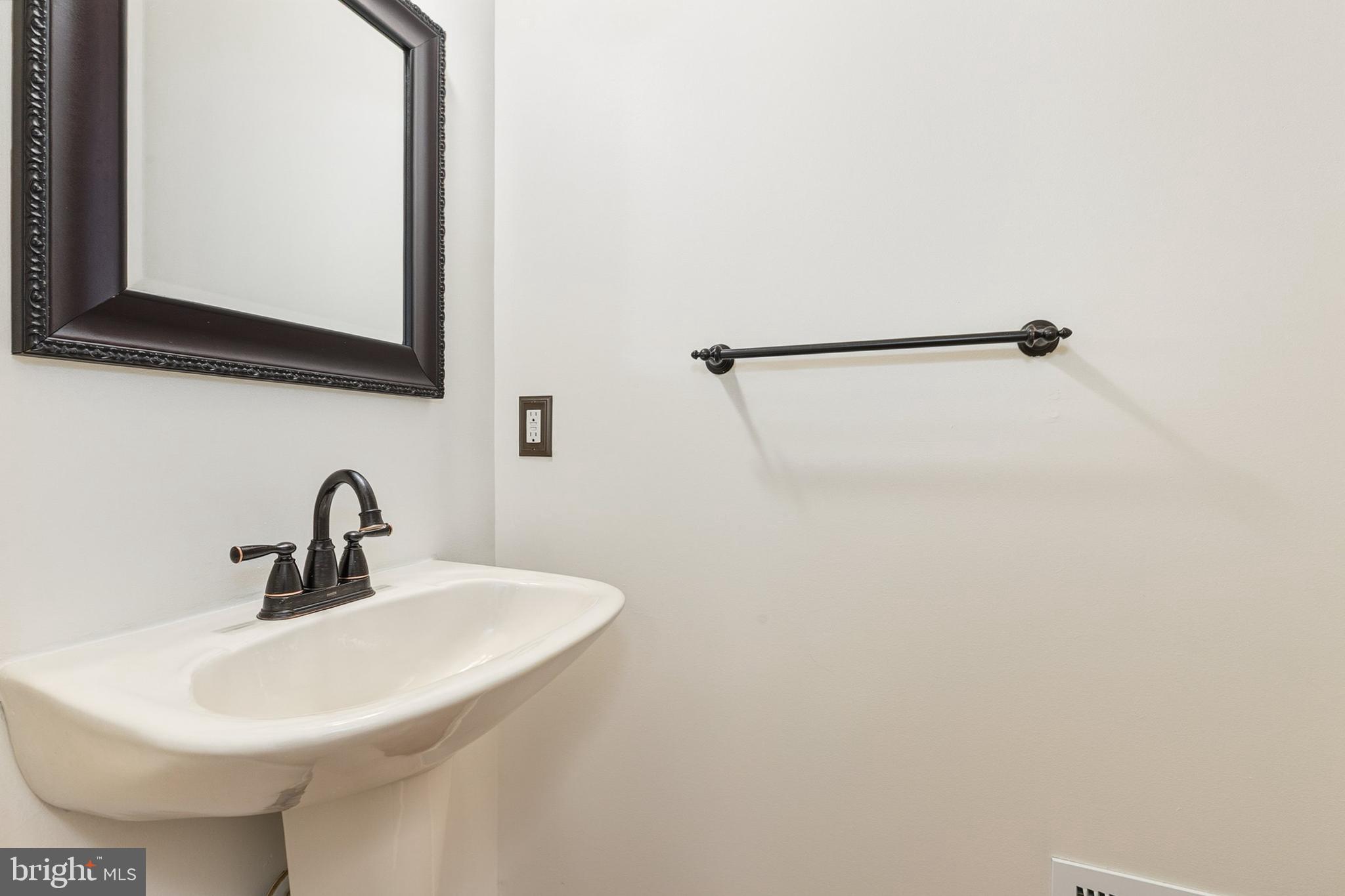 9956 Fragrant Lilies Way Laurel, MD 20723 - Photo 35 of 60 a bathroom with a sink and a mirror