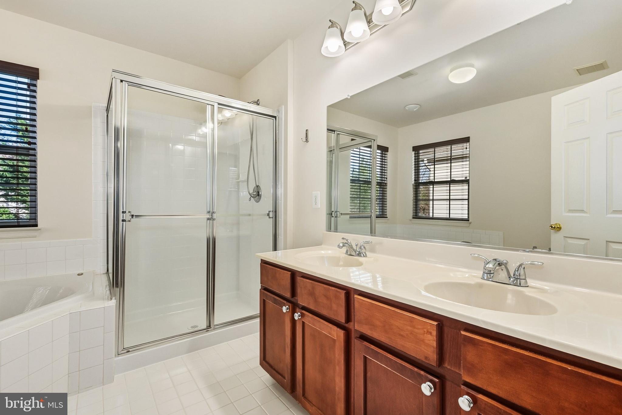 9956 Fragrant Lilies Way Laurel, MD 20723 - Photo 37 of 60 a bathroom with a sink double vanity and shower
