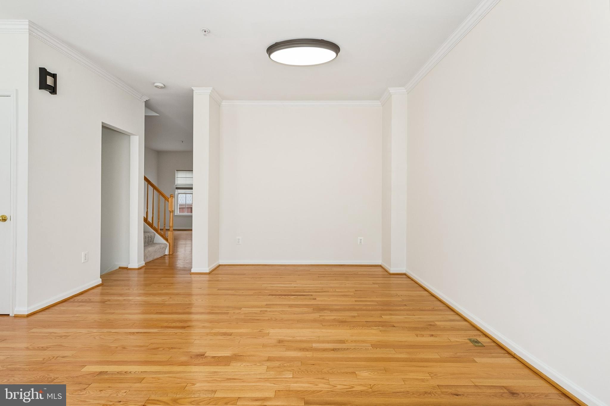 9956 Fragrant Lilies Way Laurel, MD 20723 - Photo 4 of 60 a view of an empty room with wooden floor