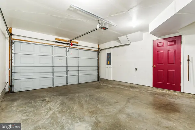 a view of a tennis ground with large trees