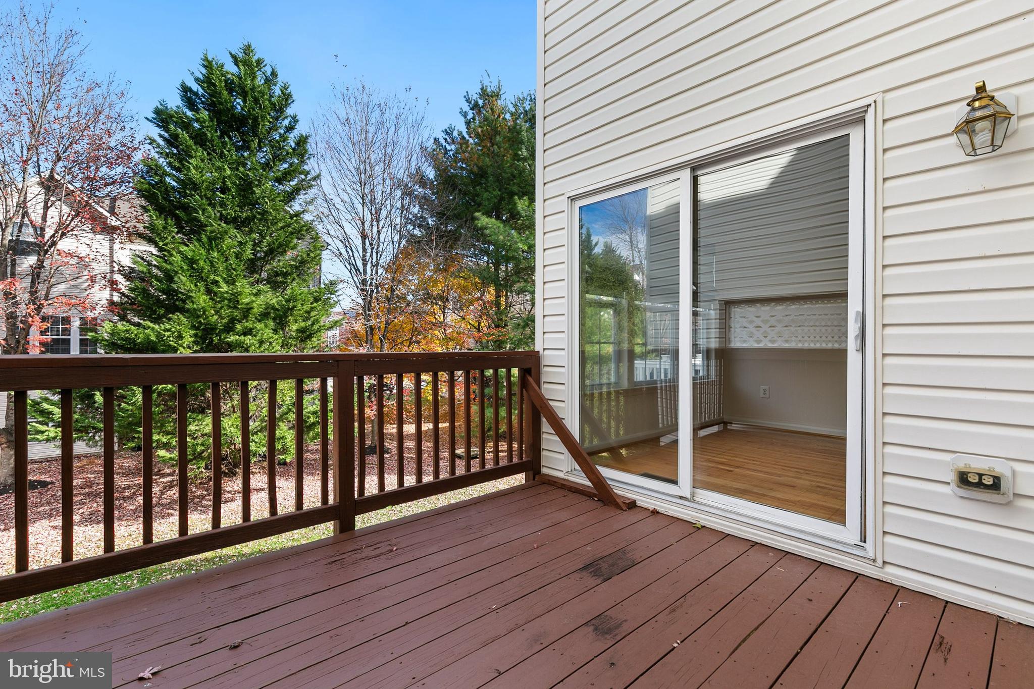 9956 Fragrant Lilies Way Laurel, MD 20723 - Photo 50 of 60 a view of a porch with wooden floor and floor to ceiling window