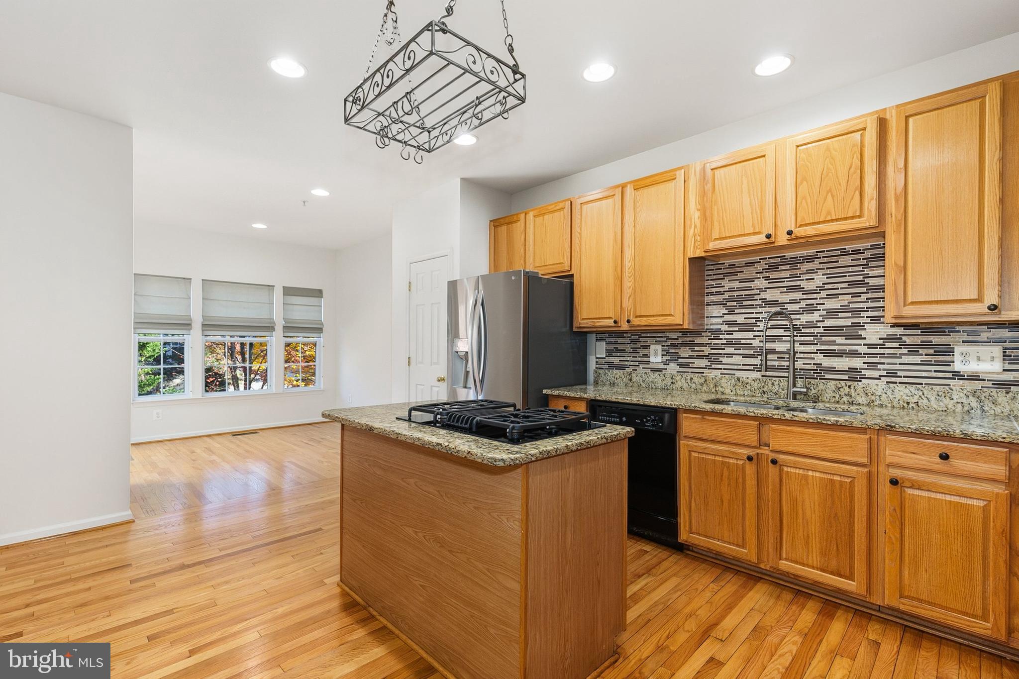 9956 Fragrant Lilies Way Laurel, MD 20723 - Photo 10 of 60 a kitchen with stainless steel appliances granite countertop a stove and cabinets