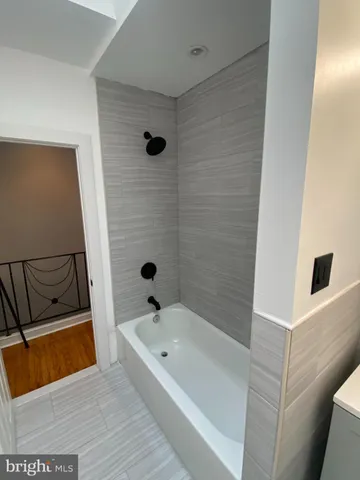 a bathroom with a tub and shower