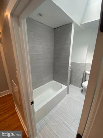 a bathroom with a bathtub and shower