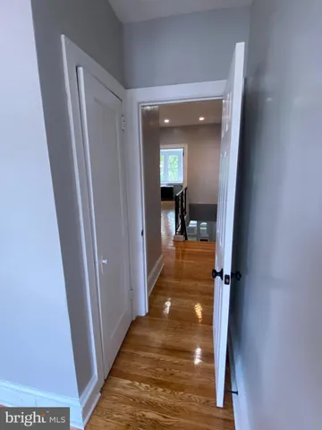 a view of a hallway view with wooden floor and staircase