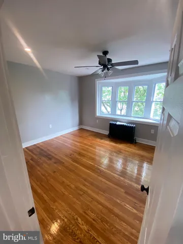 a view of empty room with a ceiling fan and window
