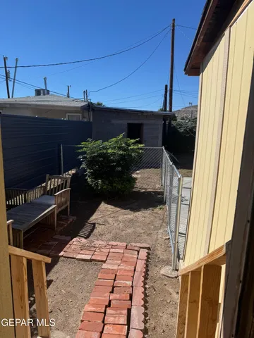 a view of a porch with chairs and potted plants