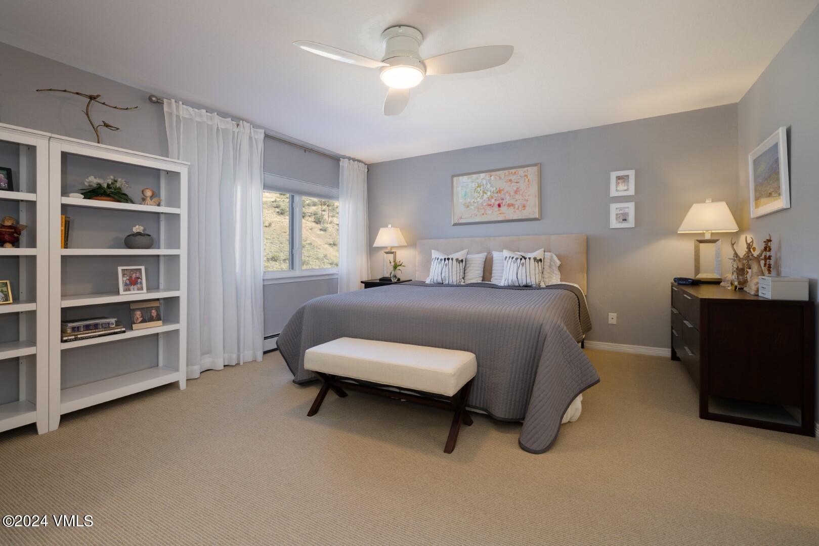 2492 Draw Spur, Unit D Avon, CO 81620 - Photo 11 of 22 a bedroom with a bed and a chandelier