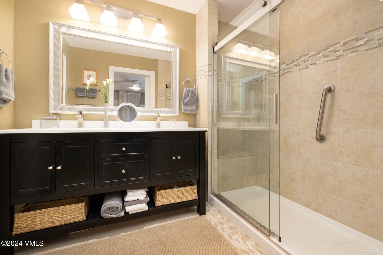 2492 Draw Spur, Unit D Avon, CO 81620 - Photo 12 of 22 a bathroom with a tub sink and mirror