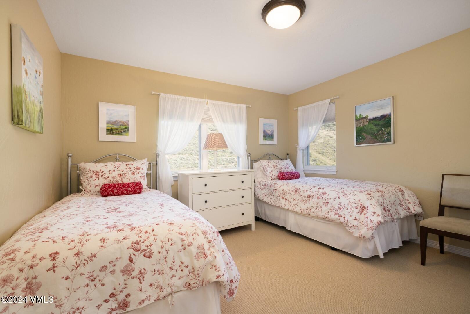 2492 Draw Spur, Unit D Avon, CO 81620 - Photo 14 of 22 a bedroom with two beds and painting on the wall