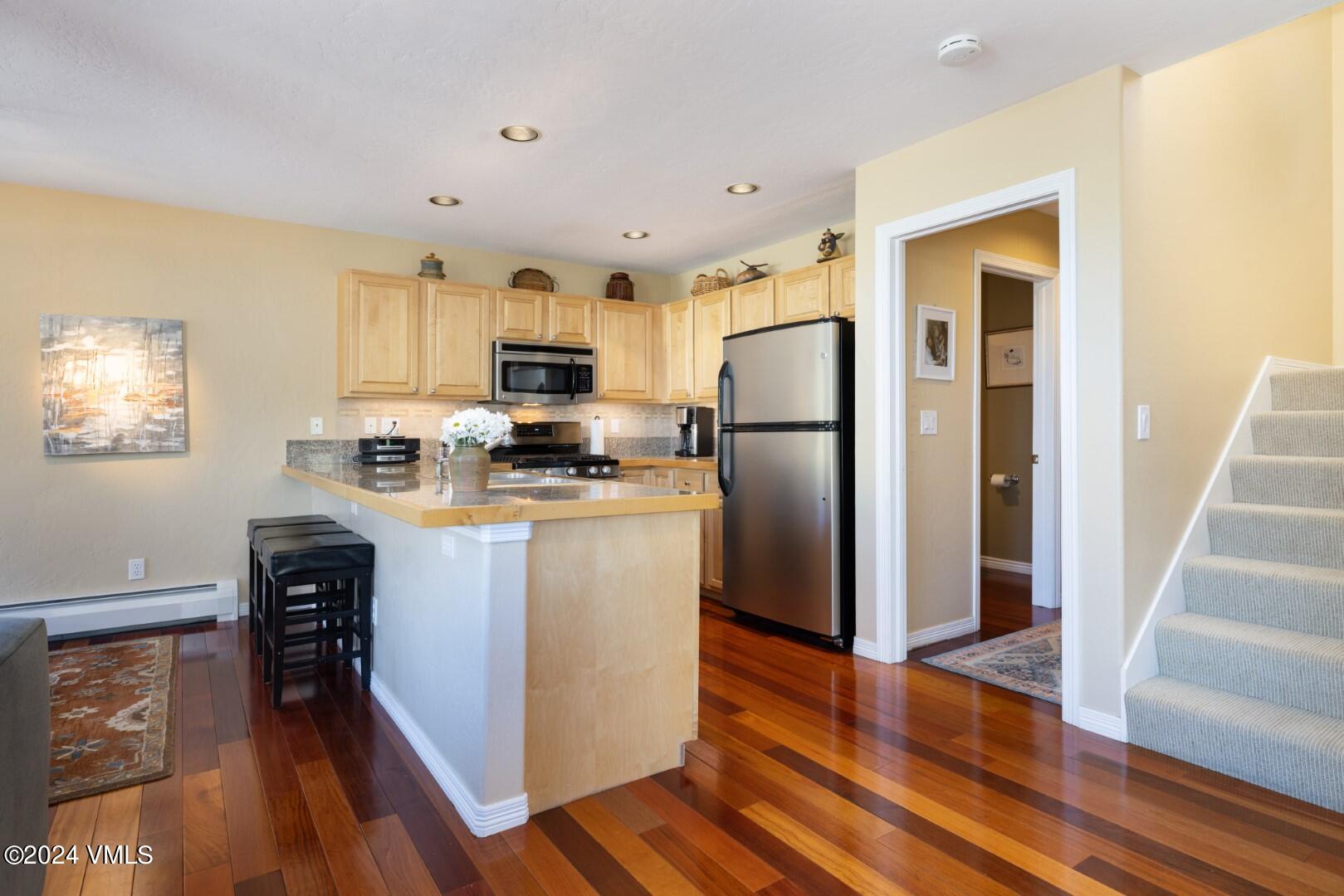 2492 Draw Spur, Unit D Avon, CO 81620 - Photo 3 of 22 a kitchen with stainless steel appliances a refrigerator stove microwave and cabinets