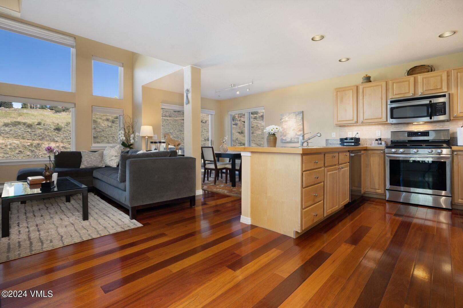 2492 Draw Spur, Unit D Avon, CO 81620 - Photo 4 of 22 a open kitchen with stainless steel appliances granite countertop a stove and a view of living room