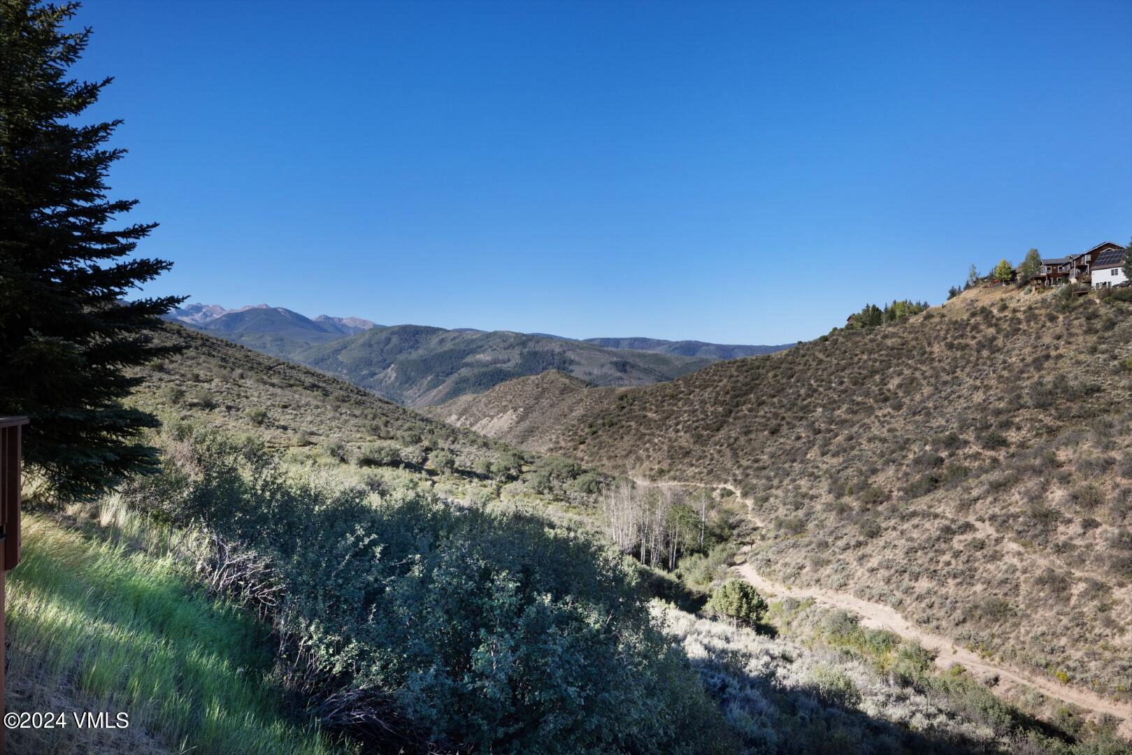 2492 Draw Spur, Unit D Avon, CO 81620 - Photo 10 of 22 a view of a dry yard with mountains in the background